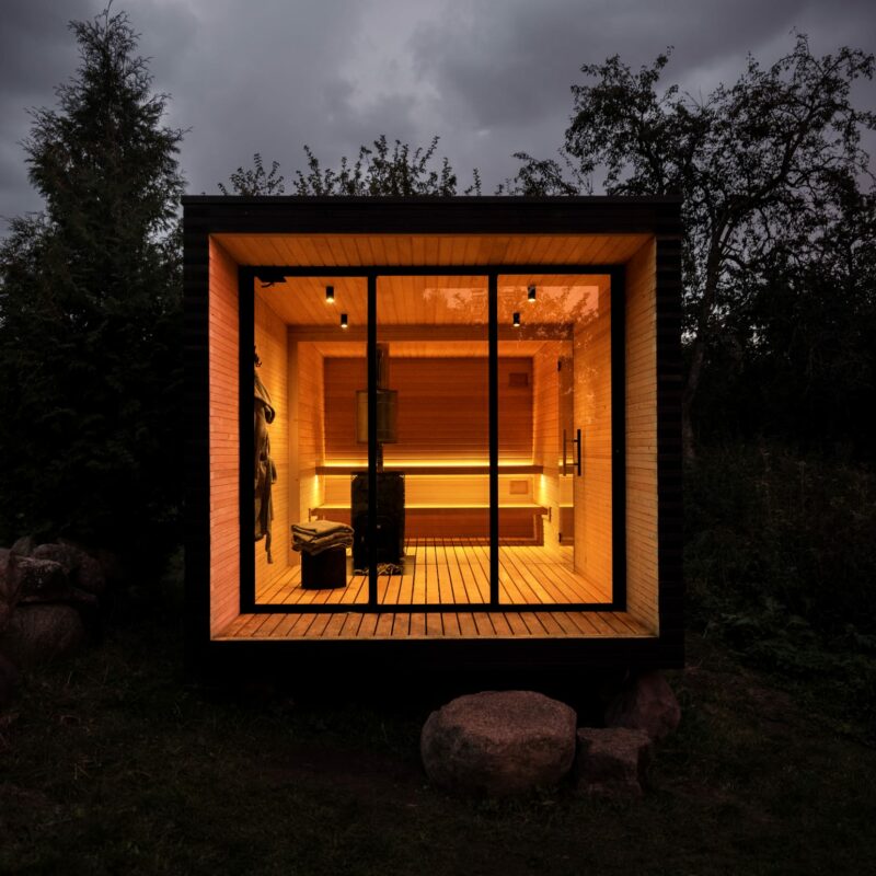 modern outdoor sauna with warm led lights inside